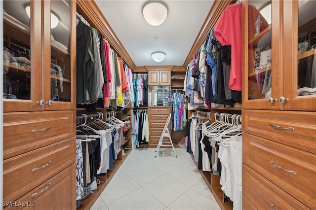 walk in closet with light tile patterned floors