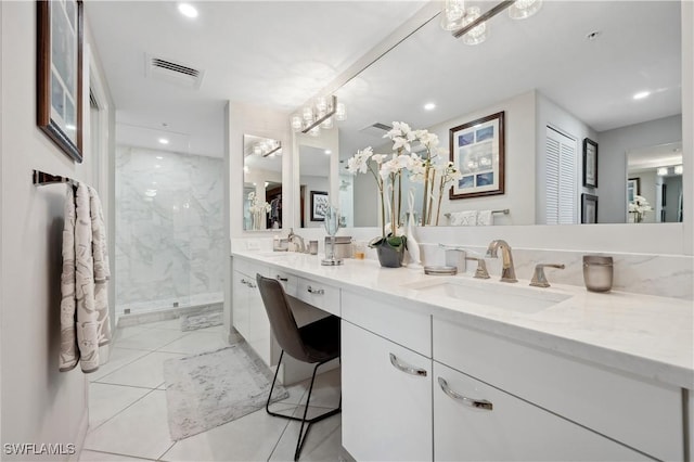 bathroom with tiled shower and vanity