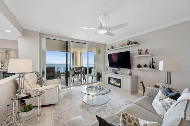 living room featuring light tile patterned flooring, ceiling fan, floor to ceiling windows, and crown molding