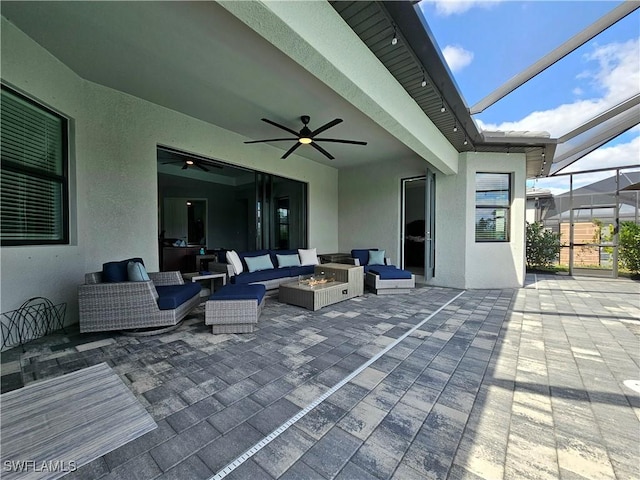 11637 Russet Trl, Fort Myers, FL 33913 - view of patio with a ceiling fan, glass enclosure, and an outdoor living space with a fire pit