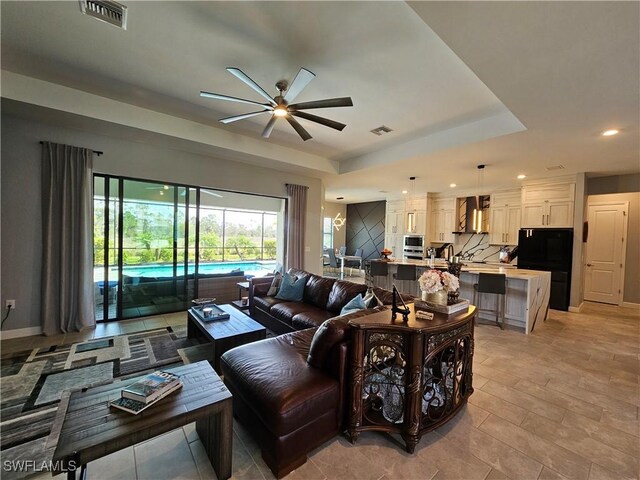 11637 Russet Trl, Fort Myers, FL 33913 - living area with ceiling fan, a tray ceiling, visible vents, and recessed lighting