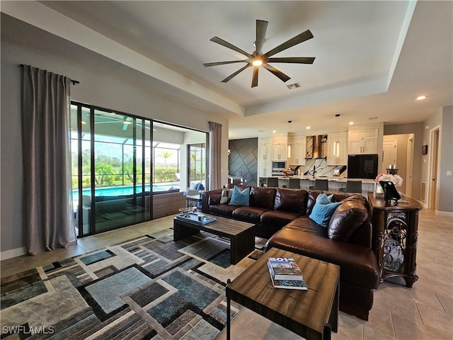 11637 Russet Trl, Fort Myers, FL 33913 - living area with baseboards, a ceiling fan, visible vents, and a raised ceiling
