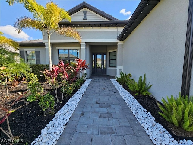 entrance to property with stucco siding