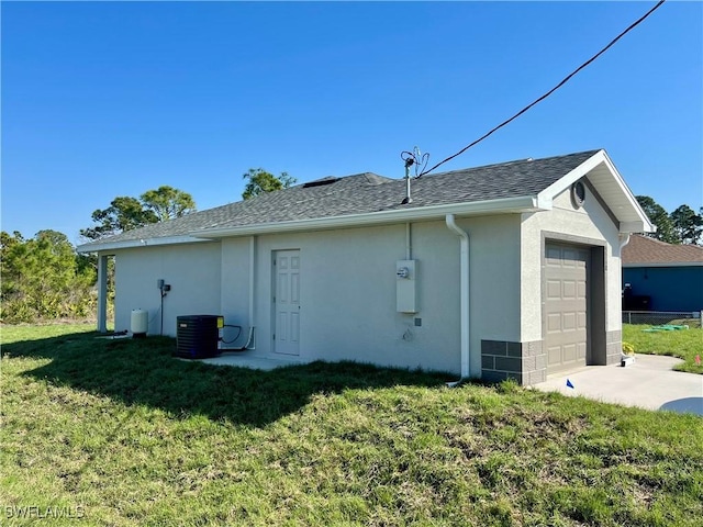 view of side of home featuring a garage, a yard, and cooling unit