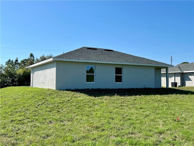 view of side of home with a yard