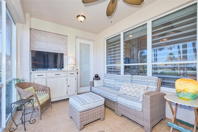 interior space with ceiling fan