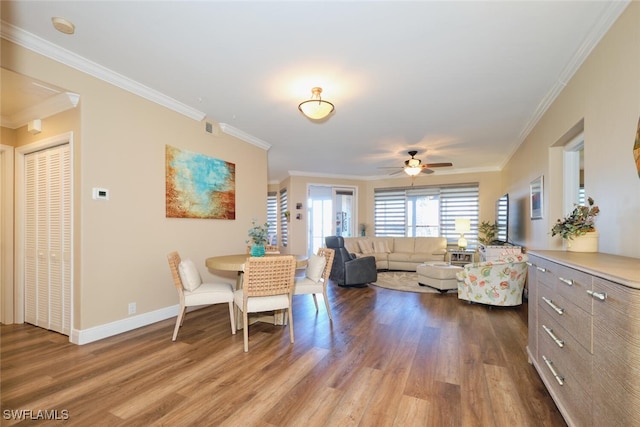 dining room featuring hardwood / wood-style flooring, crown molding, and ceiling fan