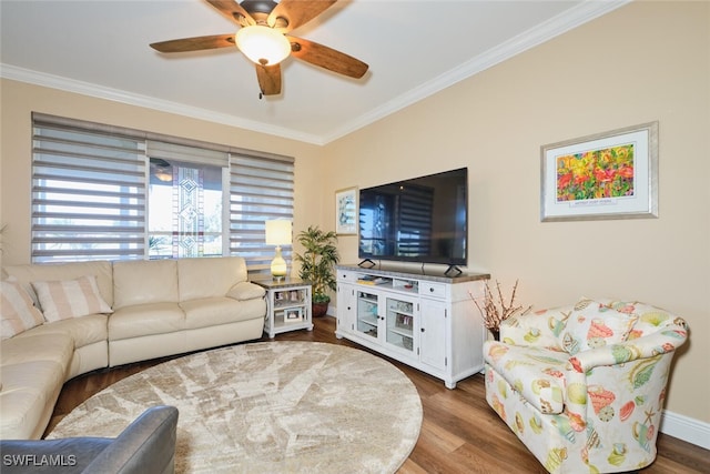 living room with hardwood / wood-style flooring, crown molding, and ceiling fan