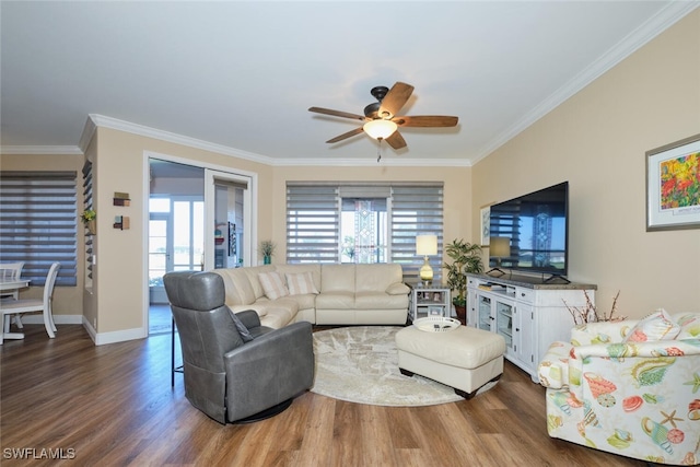 living room with ornamental molding, dark hardwood / wood-style floors, and ceiling fan