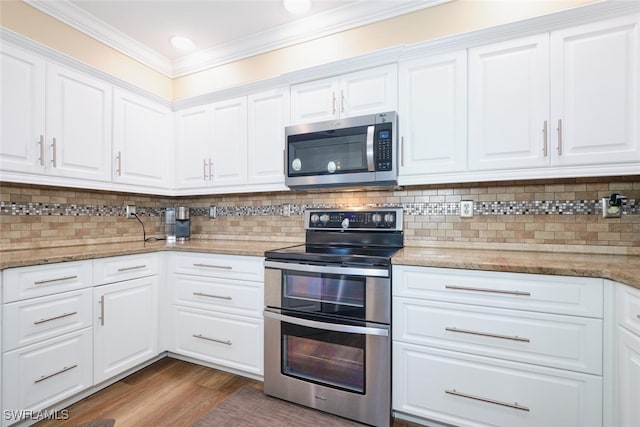 kitchen featuring appliances with stainless steel finishes, dark hardwood / wood-style floors, white cabinets, decorative backsplash, and light stone countertops