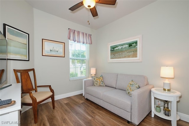 living room with dark hardwood / wood-style flooring and ceiling fan