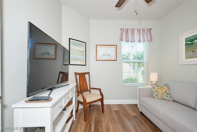 sitting room with hardwood / wood-style floors and ceiling fan