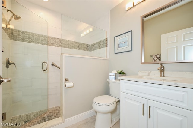 bathroom featuring vanity, a shower with shower door, and toilet