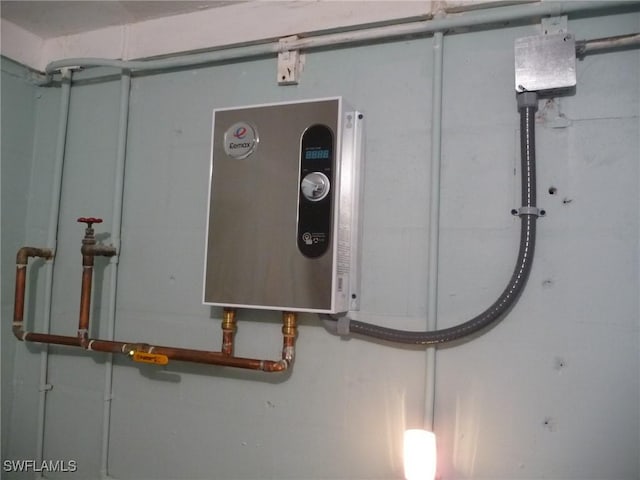 utility room featuring water heater