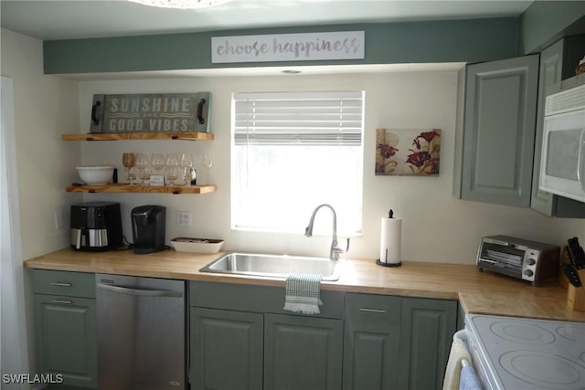 kitchen featuring white microwave, a sink, light countertops, dishwasher, and open shelves