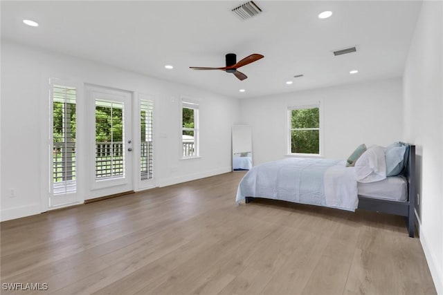 unfurnished bedroom featuring ceiling fan, access to exterior, and light hardwood / wood-style floors