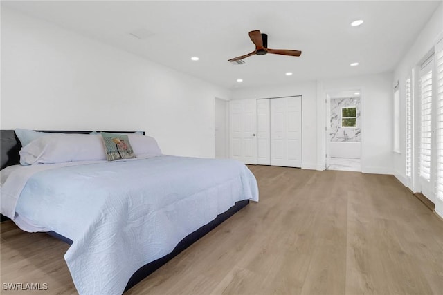 bedroom featuring ceiling fan, connected bathroom, and light hardwood / wood-style floors