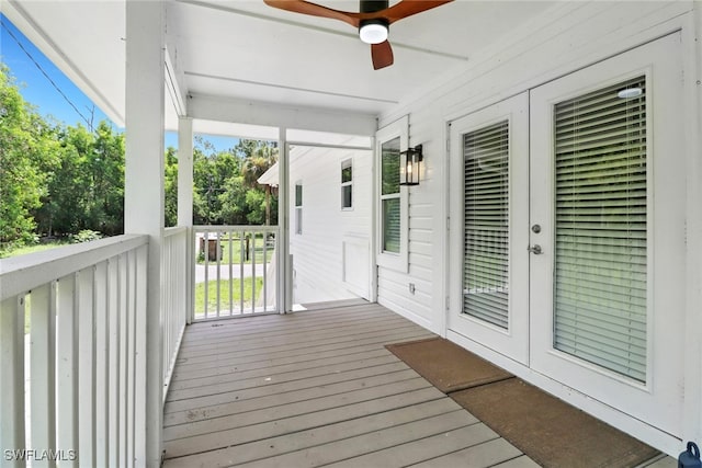 wooden terrace with ceiling fan and a porch