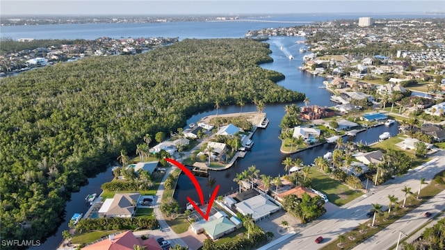 drone / aerial view featuring a residential view and a water view