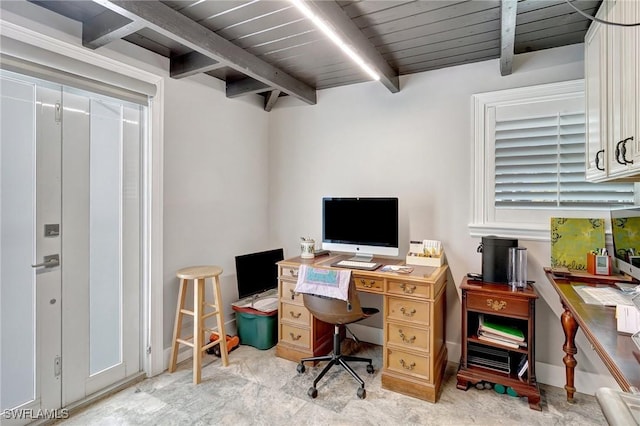 office area with baseboards and beam ceiling