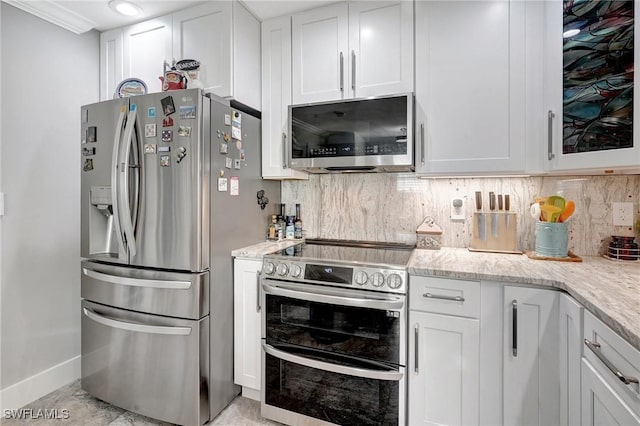 kitchen with decorative backsplash, white cabinetry, and stainless steel appliances