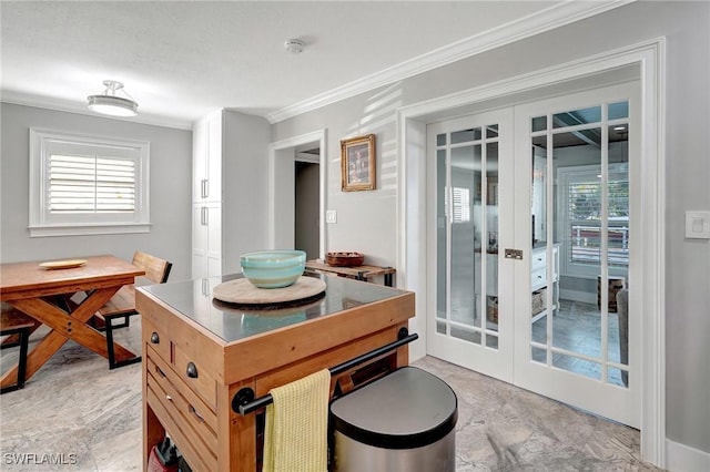 dining room with ornamental molding and french doors