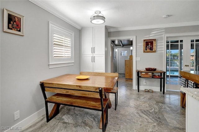 dining room with french doors, baseboards, and ornamental molding