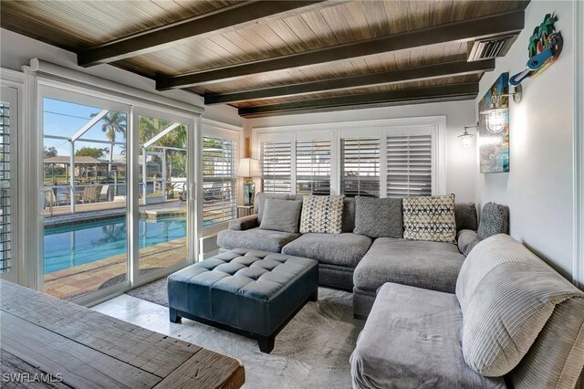 living room with beam ceiling and visible vents