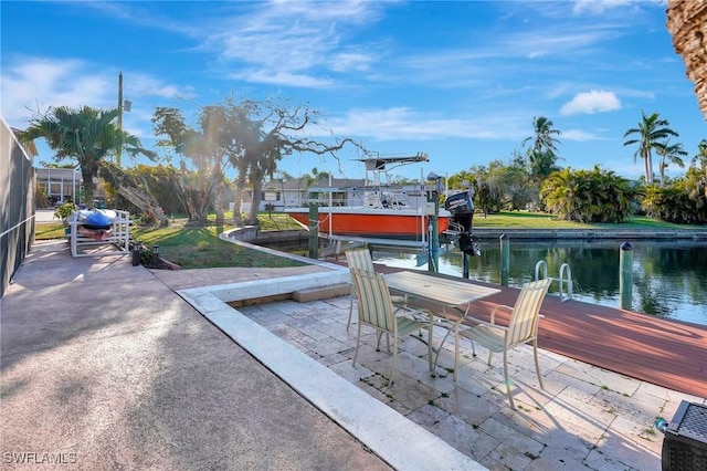 view of patio / terrace with a dock, a water view, and boat lift