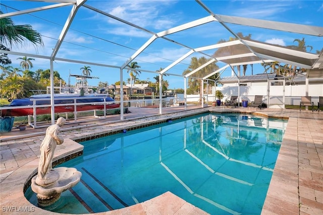 view of swimming pool with a fenced in pool, a patio area, and a lanai