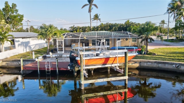 dock area featuring a lanai, boat lift, fence, and a water view