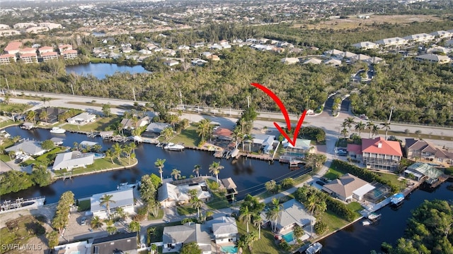 drone / aerial view featuring a water view and a residential view