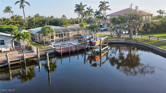 view of dock with a water view, glass enclosure, and boat lift