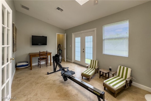 exercise room featuring lofted ceiling and french doors