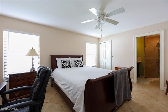 tiled bedroom featuring ceiling fan and a closet