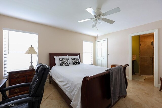 bedroom with light tile patterned floors, ceiling fan, and a closet