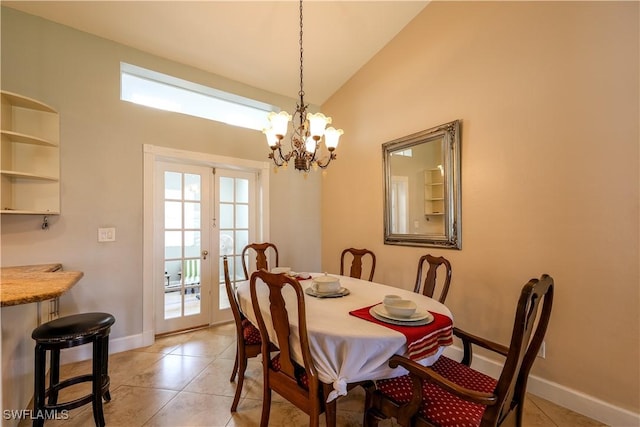 dining room with light tile patterned flooring, lofted ceiling, an inviting chandelier, and french doors