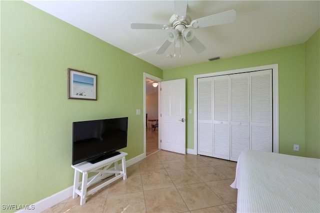 tiled bedroom with a closet and ceiling fan