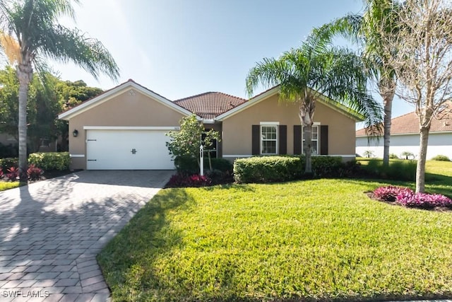 ranch-style house with a garage and a front lawn