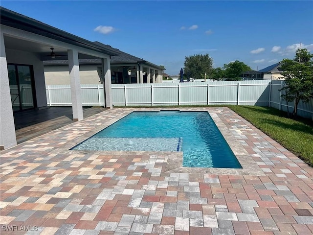 view of swimming pool featuring ceiling fan and a patio