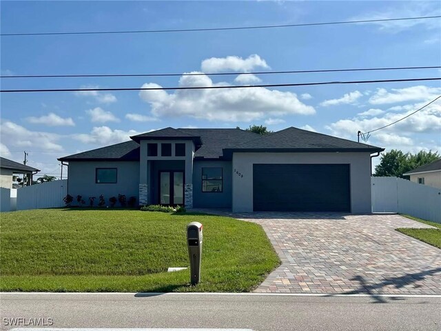 view of front of property featuring a garage and a front yard