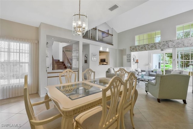 dining area with a chandelier, light tile patterned flooring, visible vents, and a healthy amount of sunlight