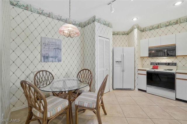 kitchen with white appliances, light tile patterned floors, wallpapered walls, white cabinets, and light countertops