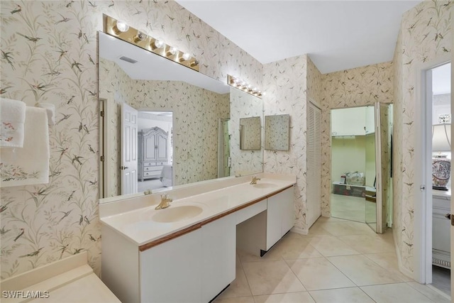 full bath with a sink, tile patterned floors, connected bathroom, and wallpapered walls