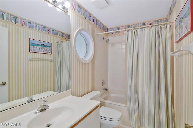 full bath featuring shower / bath combo, vanity, toilet, and wallpapered walls