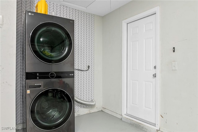 laundry room with stacked washing maching and dryer