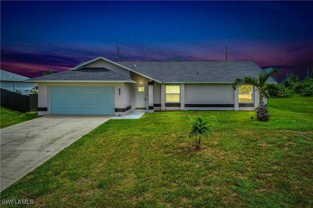 single story home with a yard and a garage