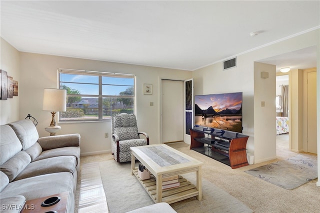 carpeted living room with ornamental molding