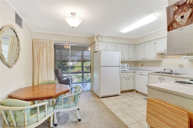 kitchen with white cabinetry, sink, light tile patterned floors, crown molding, and white appliances