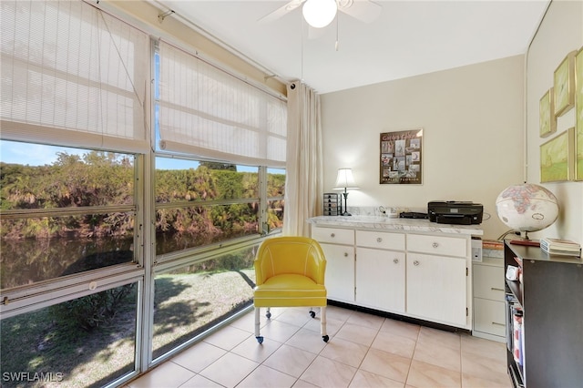 interior space with ceiling fan and light tile patterned floors